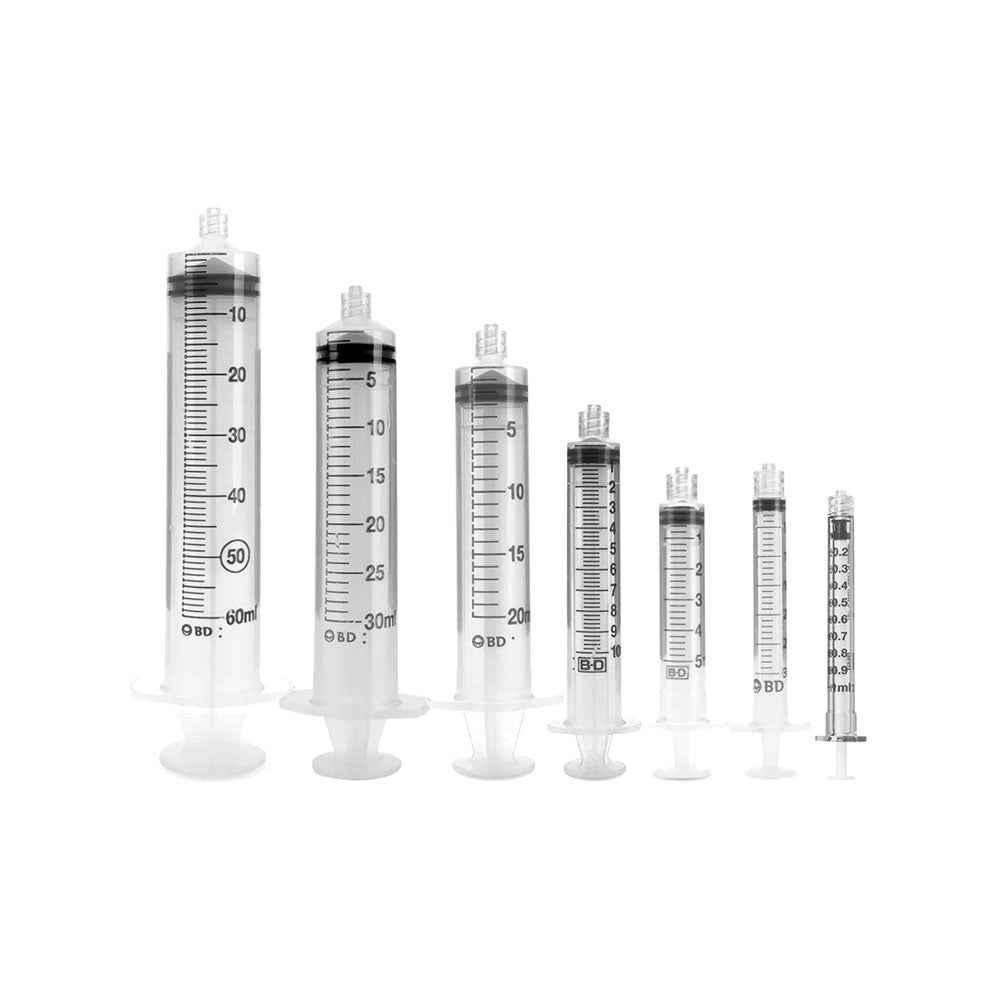 A row of six MedPharma USA syringes, ranging from 1ml to 60ml, arranged in increasing size from right to left. They are clear plastic with black markings and white plungers, featuring a 10cc Becton Dickinson syringe with an attached needle, set against a white background.