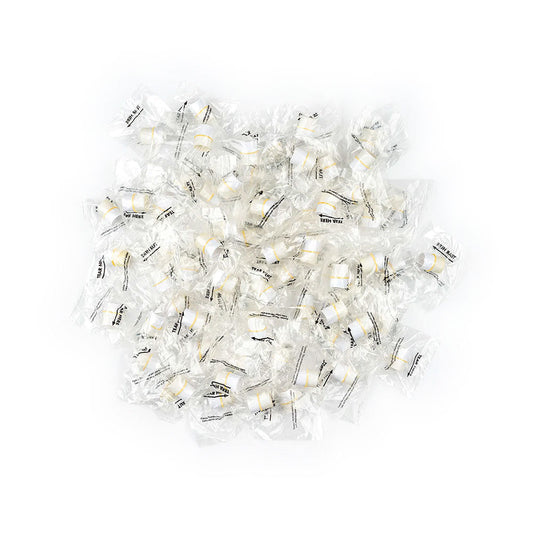 A scattered pile of fortune cookies in clear wrappers, featuring black text, lies on a white background. These wrappers resemble the precision and hygiene of MedPharma USAs Tonometer Tip Covers, Individually Wrapped, 300/Box.