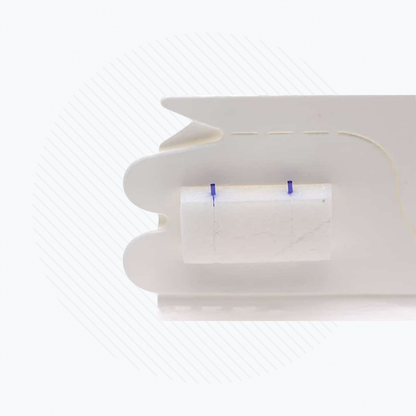 This image features a close-up of a white plastic object with a small rectangular component, akin to Lacriveras Vera180 Synthetic Absorbable Lacrimal Plugs. The background has a light striped pattern, evoking precision typical in dry eye treatment devices.