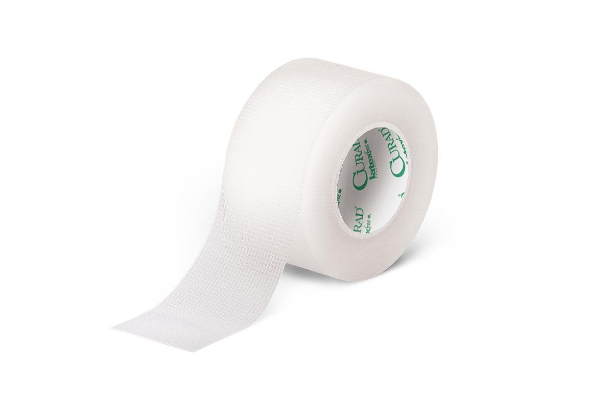 A roll of Transpore 1 x 10 Yards medical tape by MedPharma USA is partially unrolled, showing a grid texture perfect for wound care. The inner core features green printing.