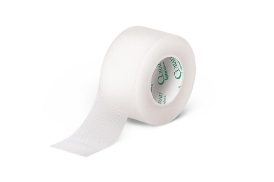 A roll of Transpore 1 x 10 Yards medical tape by MedPharma USA is partially unrolled, showing a grid texture perfect for wound care. The inner core features green printing.