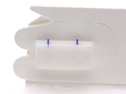 A close-up of Lacrivera Vera180 Synthetic Absorbable Lacrimal Plugs shows a white plastic design for dry eye treatment. A central rectangle is flanked by two blue lines, detailed against a plain white background.